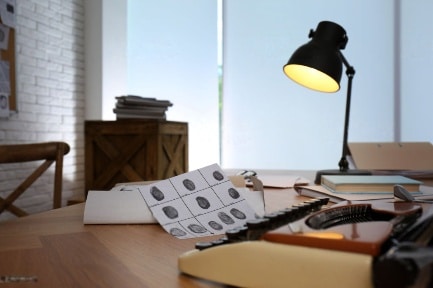 Desk with typewriter and fingerprint sheets
