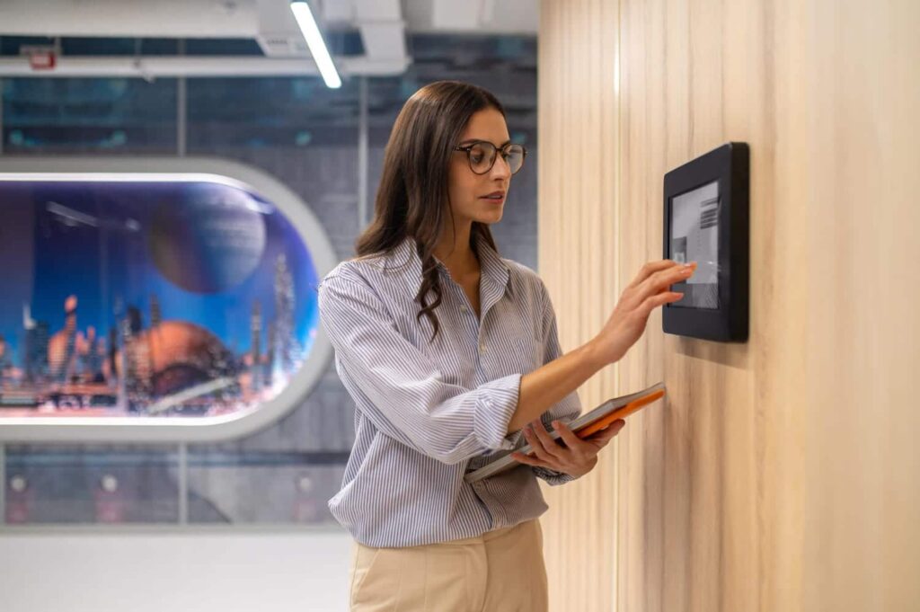 Woman pressing her finger on a fingerprinting pad screen for identity verification at a fingerprinting center in Las Vegas.