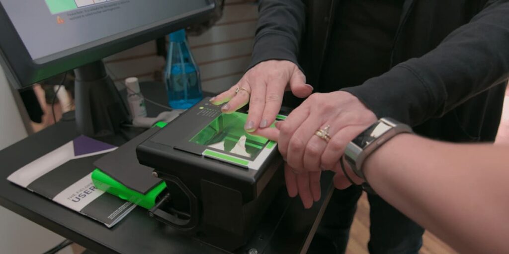 Technician performing mobile Live Scan fingerprinting at a client’s location