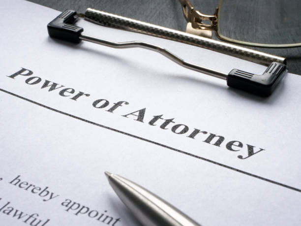 A close-up of a power of attorney document on a clipboard with a pen and eyeglasses, representing legal authorization and professional document preparation.