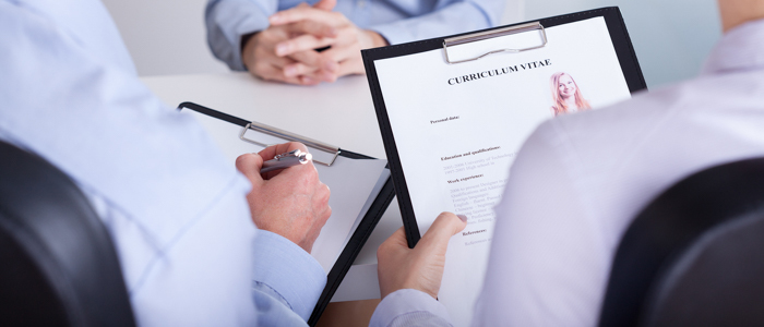 HR professional reviewing background check reports for employment screening"