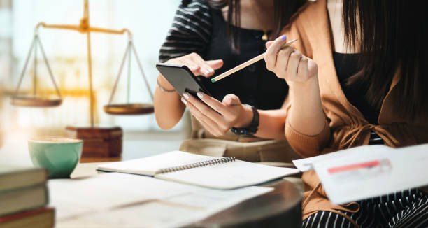 Mobile notary and apostille services with clients reviewing legal documents and using smartphone