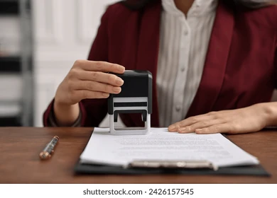 notary stamping document table office