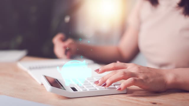 Tax preparer calculating tax documents and preparing ITIN W-7 packet for IRS submission